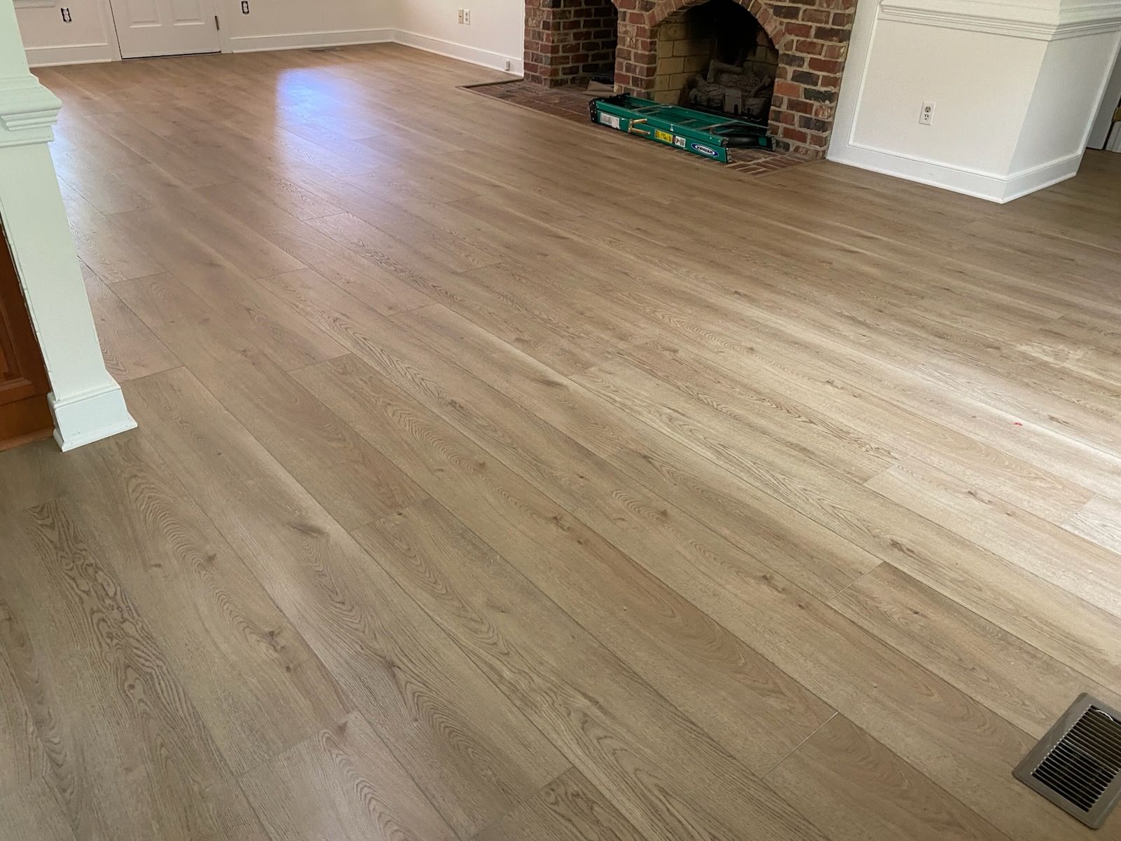 Luxury vinyl plank in a living room with a brick fireplace
